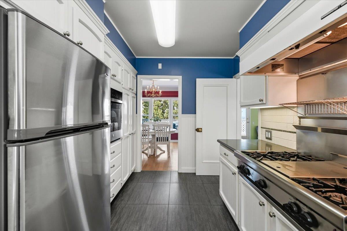 330 41st Avenue San Mateo, CA 94403 - Photo 20 of 38 a kitchen with a refrigerator a stove and white cabinets