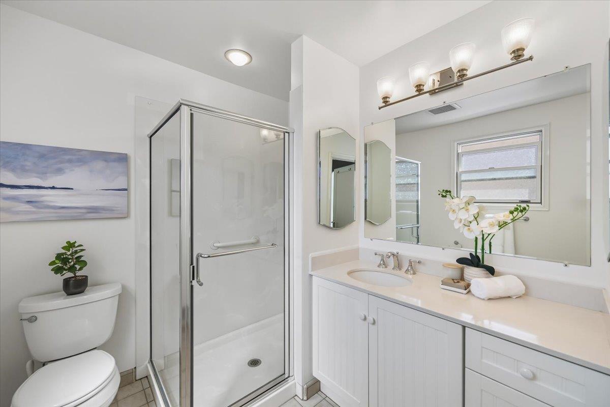 330 41st Avenue San Mateo, CA 94403 - Photo 32 of 38 a bathroom with a granite countertop sink a toilet and shower