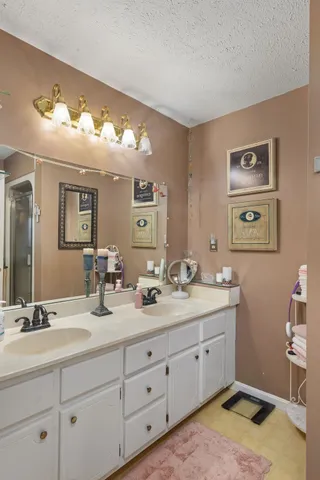 a bathroom with double sink and a mirror