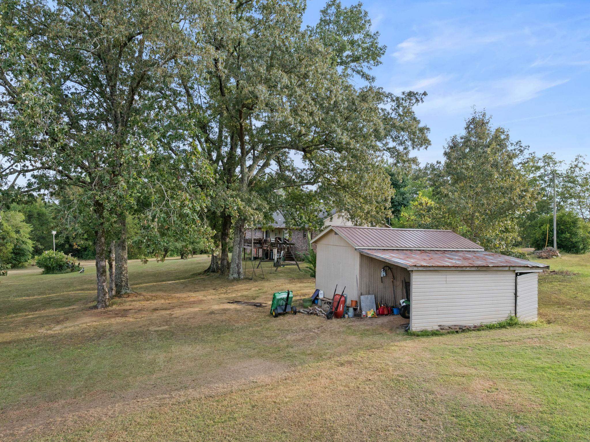 116 County Road 713 Corinth, MS 38834 - Photo 15 of 40 View of green lawn featuring an outbuilding, view of scattered trees, and a pole building