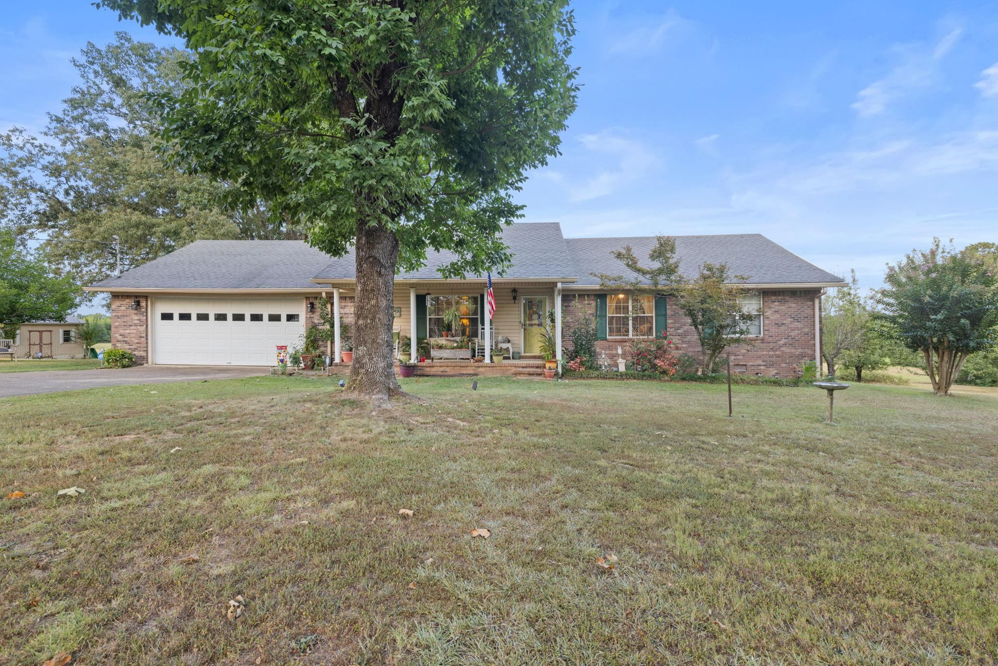 116 County Road 713 Corinth, MS 38834 - Photo 22 of 40 a front view of a house with a yard and garage