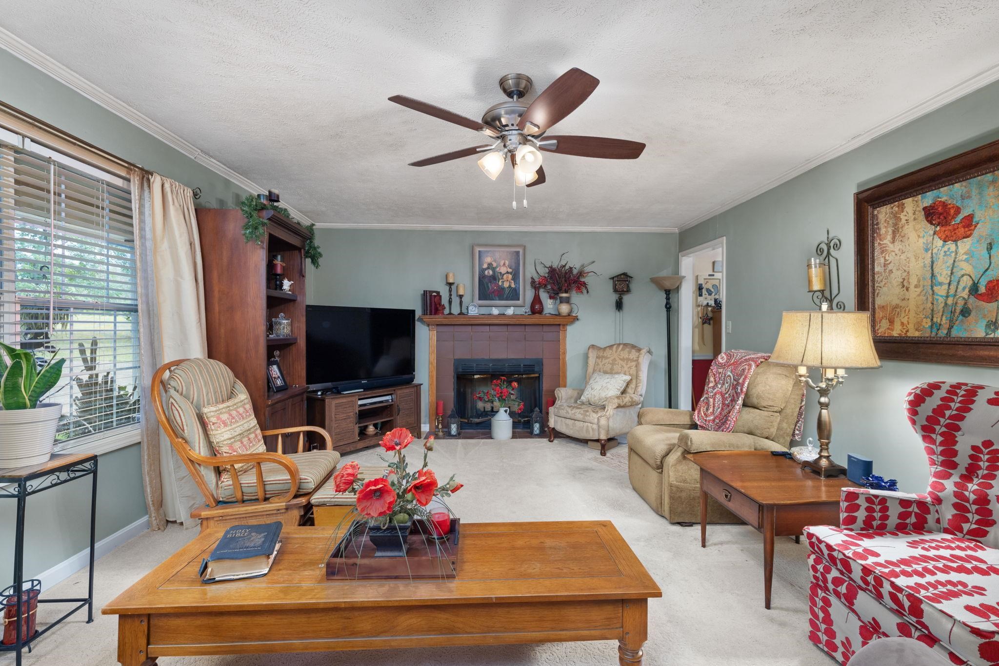 116 County Road 713 Corinth, MS 38834 - Photo 26 of 40 a living room with fireplace furniture and a flat screen tv