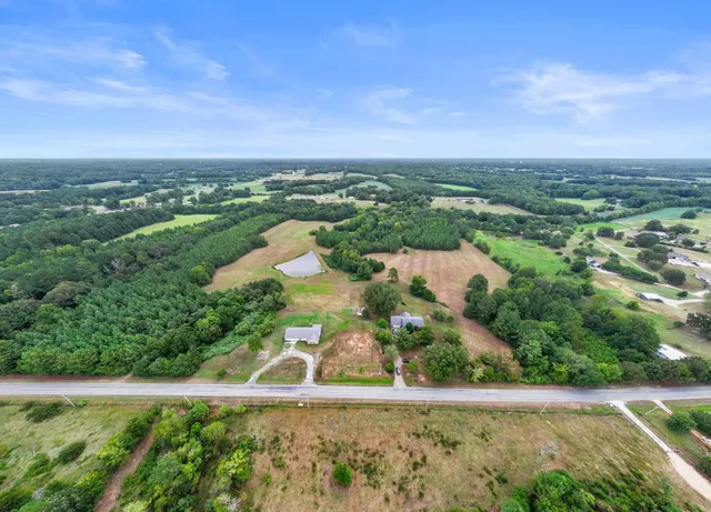 a view of a lush green outdoor space with a lake view