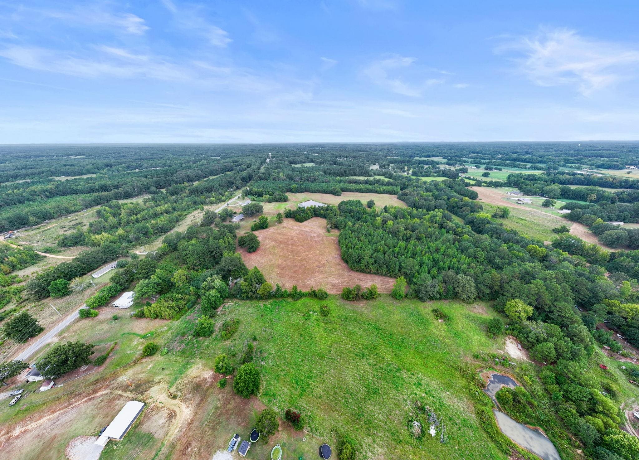 116 County Road 713 Corinth, MS 38834 - Photo 6 of 40 a view of a lush green outdoor space with a lake view