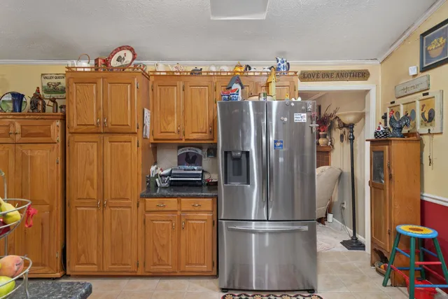 a kitchen with stainless steel appliances granite countertop a refrigerator and a stove top oven