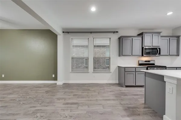 a view of a kitchen with microwave and cabinets