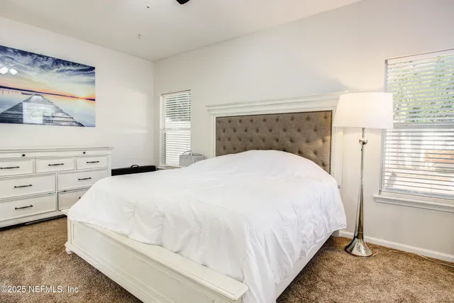 a large white bed in a white room