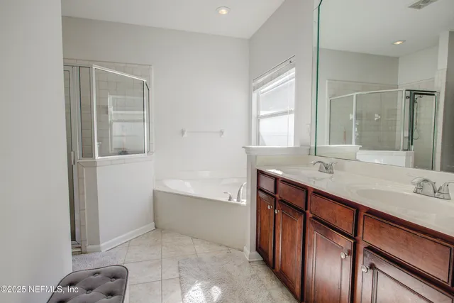 a bathroom with a sink mirror and a bathtub