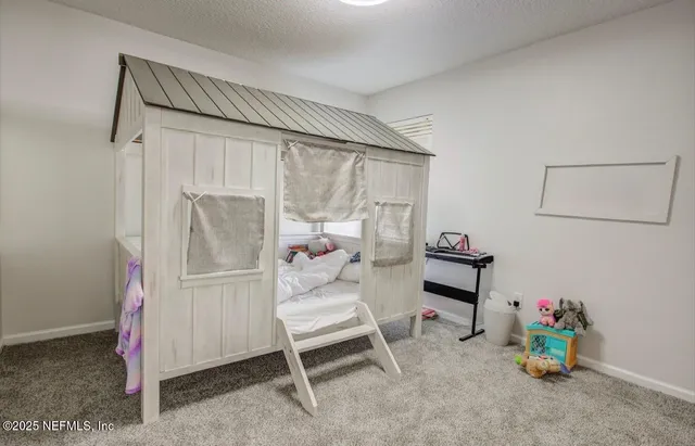 a living room with furniture flowerpot and a window