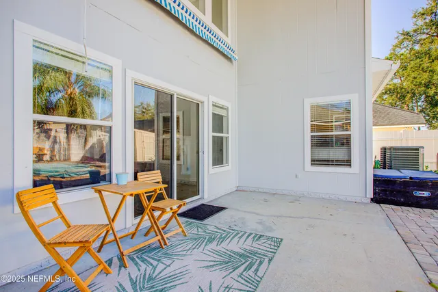 a backyard of a house with wooden floor and stairs