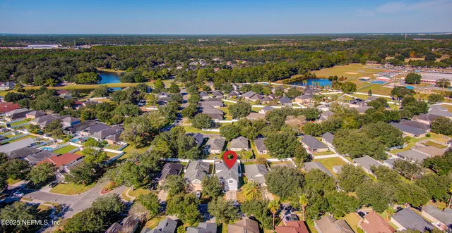 an aerial view of a swimming pool patio and outdoor seating