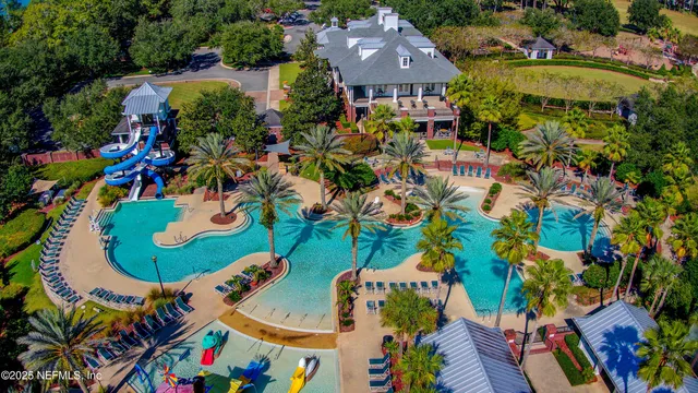 an aerial view of a house with a yard and a large tree