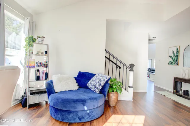 a living room with furniture and a potted plant