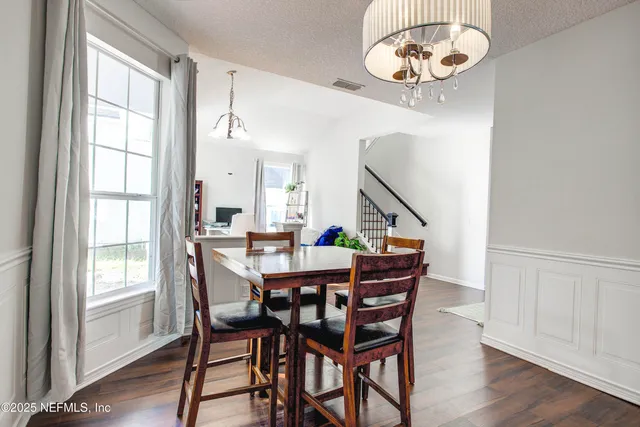 a view of a dining room with furniture window and wooden floor