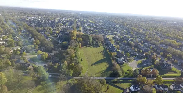 an aerial view of residential houses with outdoor space