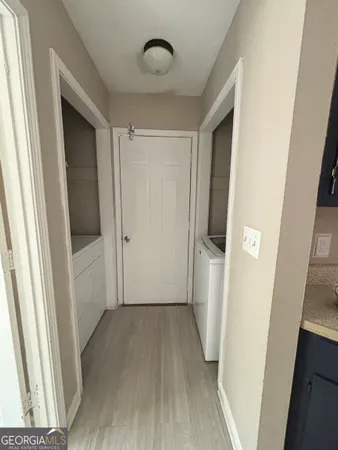 a view of entryway with hallway and wooden floor