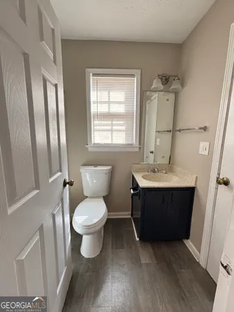 a bathroom with a toilet sink and mirror