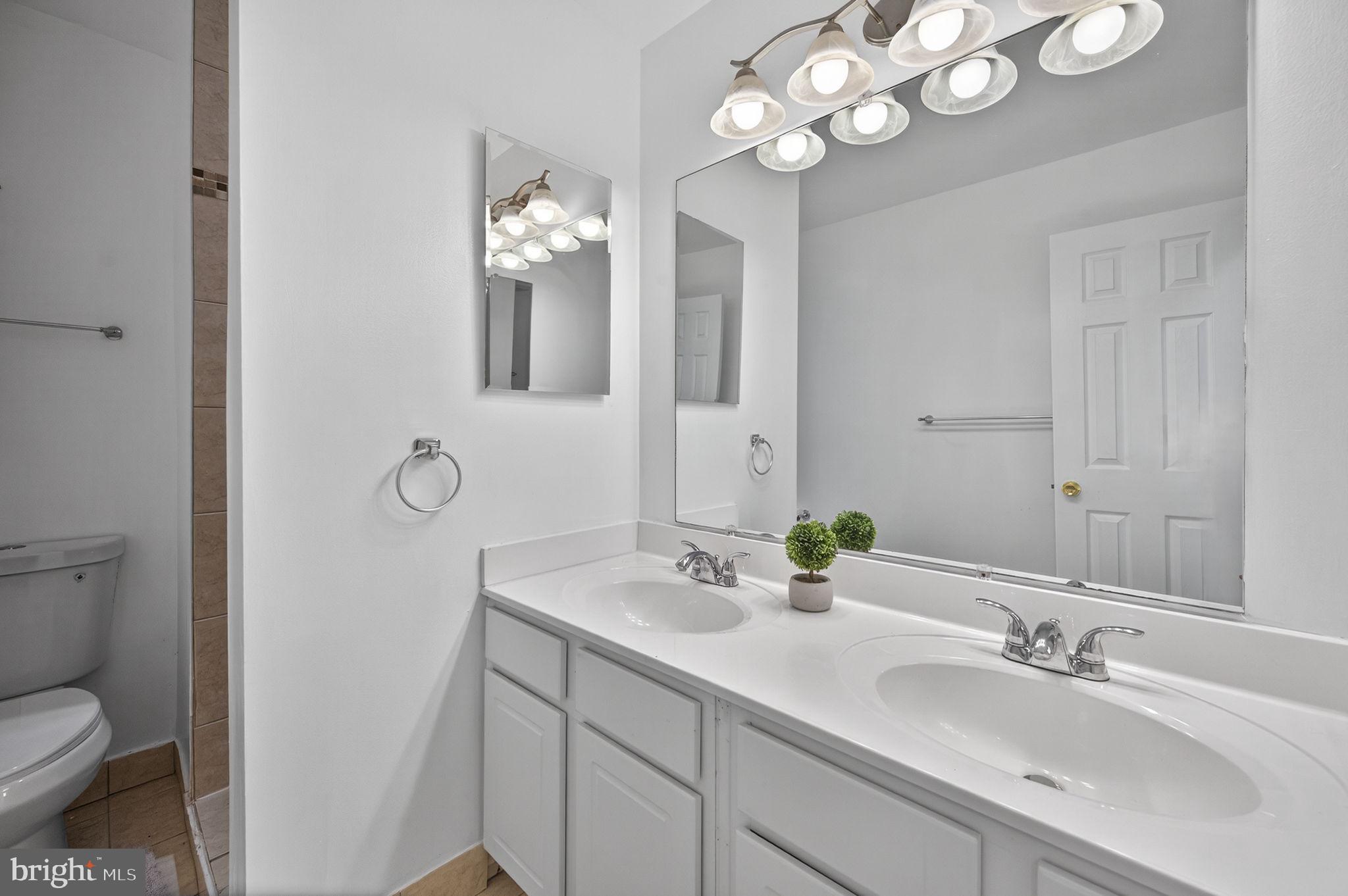 10600 Vantage Court Potomac, MD 20854 - Photo 27 of 91 a bathroom with a toilet sink and mirror
