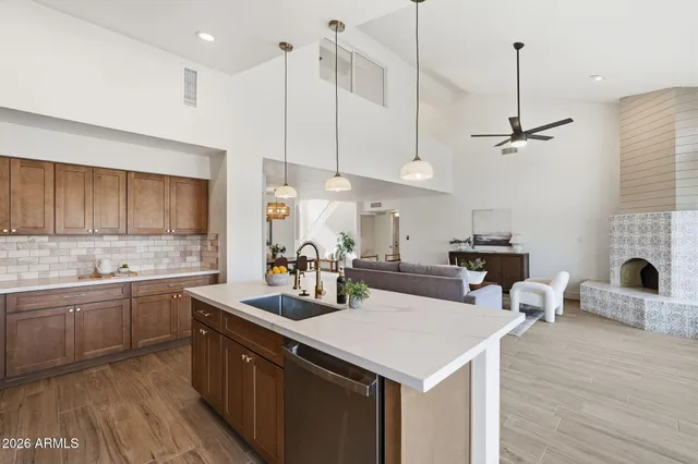 a kitchen with a sink a counter space appliances and cabinets