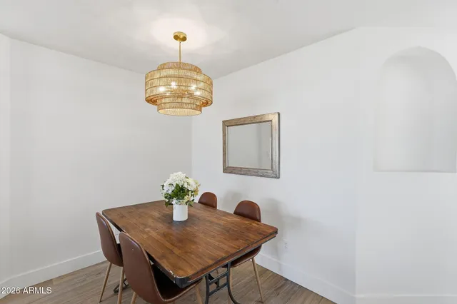 a kitchen with a sink a counter and chairs