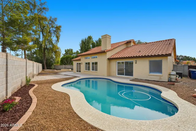 a view of a swimming pool with a yard