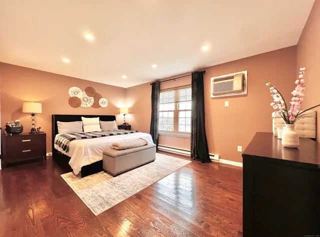 a bedroom with a large bed and a night stand