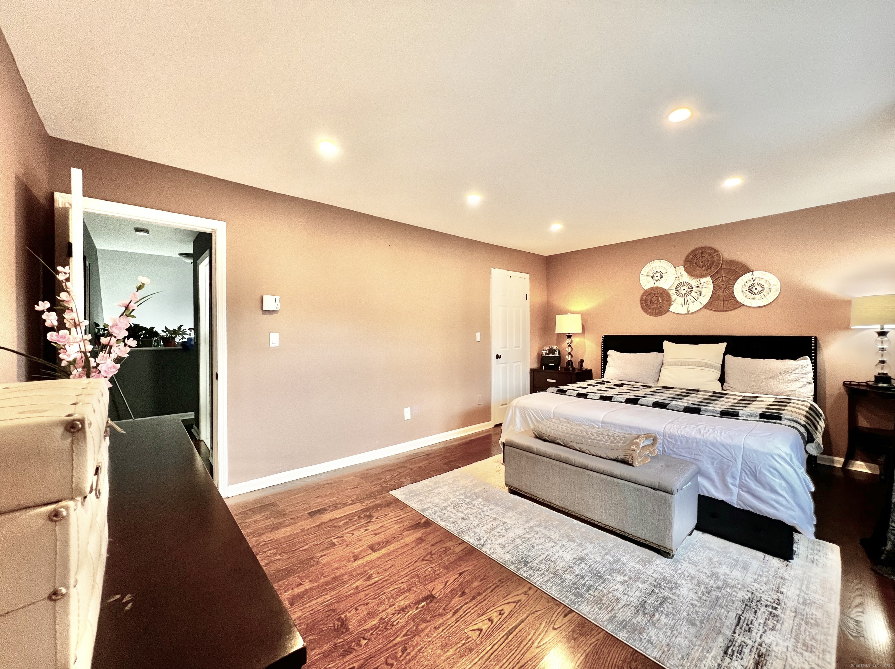 782 Oronoke Road, Unit 27 Waterbury, CT 06708 - Photo 15 of 28 a bedroom with a large bed and a chandelier