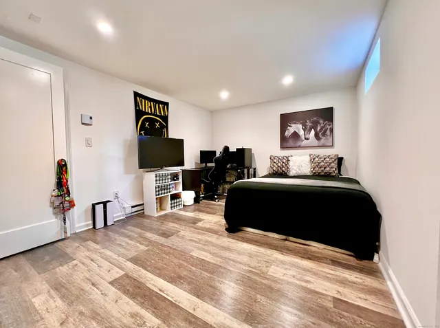 a bedroom with a bed and a flat screen tv