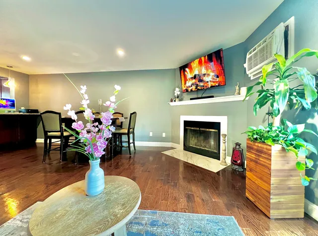 a living room with furniture a fireplace and a flat screen tv