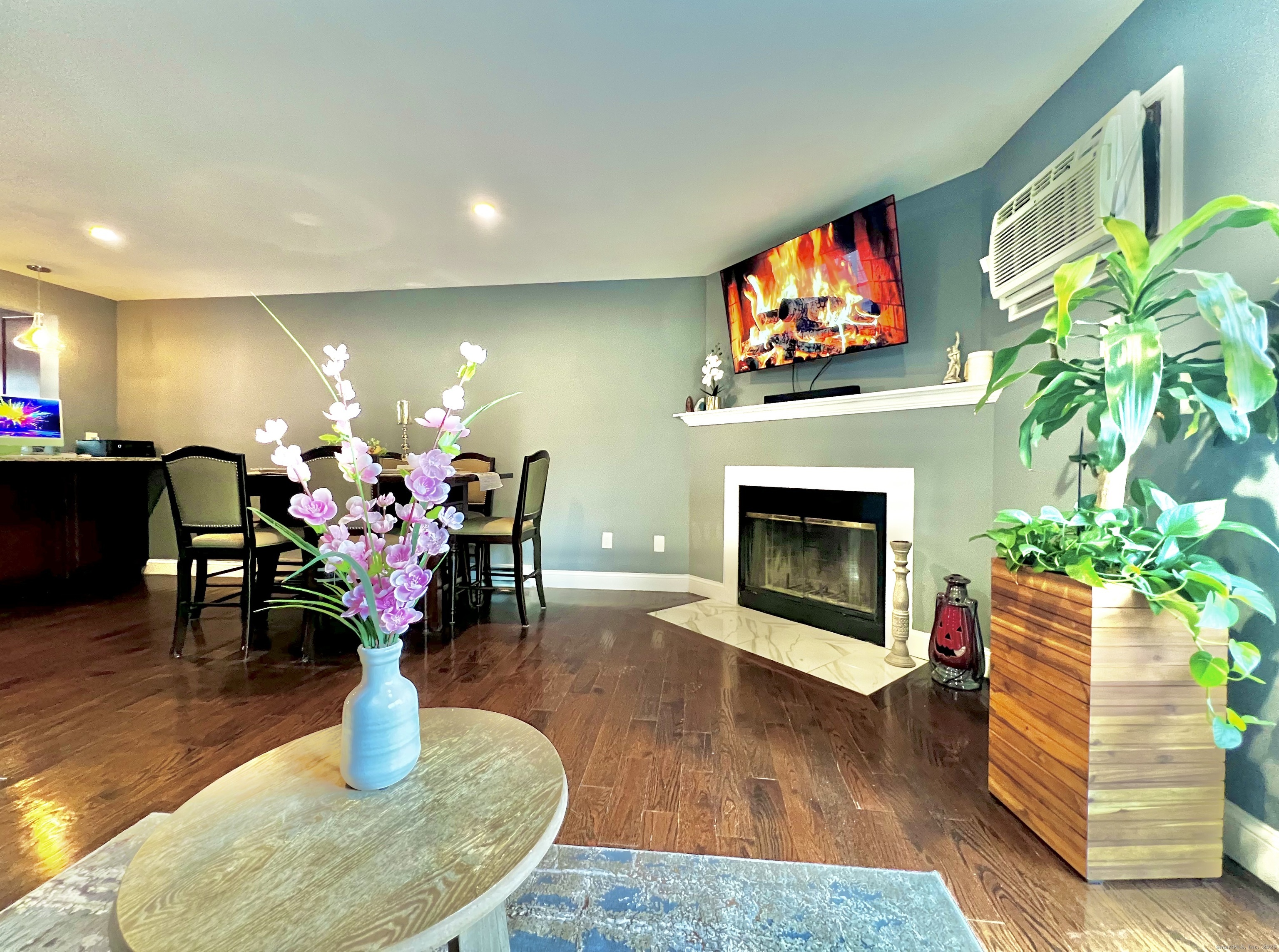 782 Oronoke Road, Unit 27 Waterbury, CT 06708 - Photo 2 of 28 a living room with furniture a fireplace and a flat screen tv