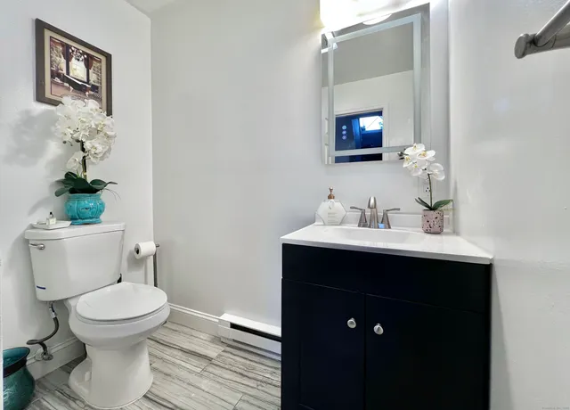 a bathroom with a toilet sink and mirror
