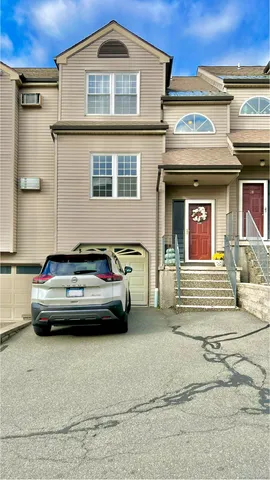 a view of building with car parked