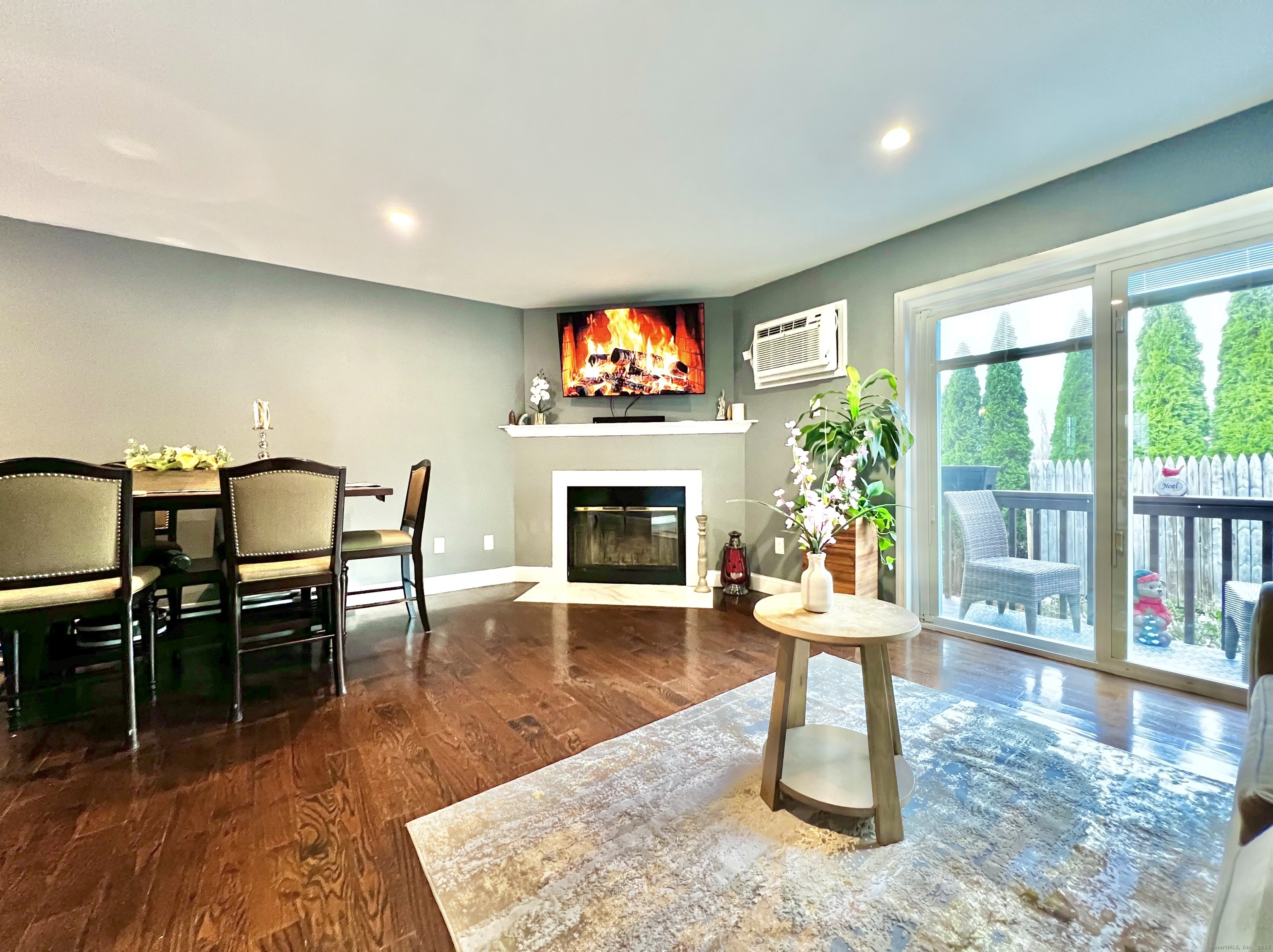 782 Oronoke Road, Unit 27 Waterbury, CT 06708 - Photo 4 of 28 a dining room with furniture a fireplace and wooden floor