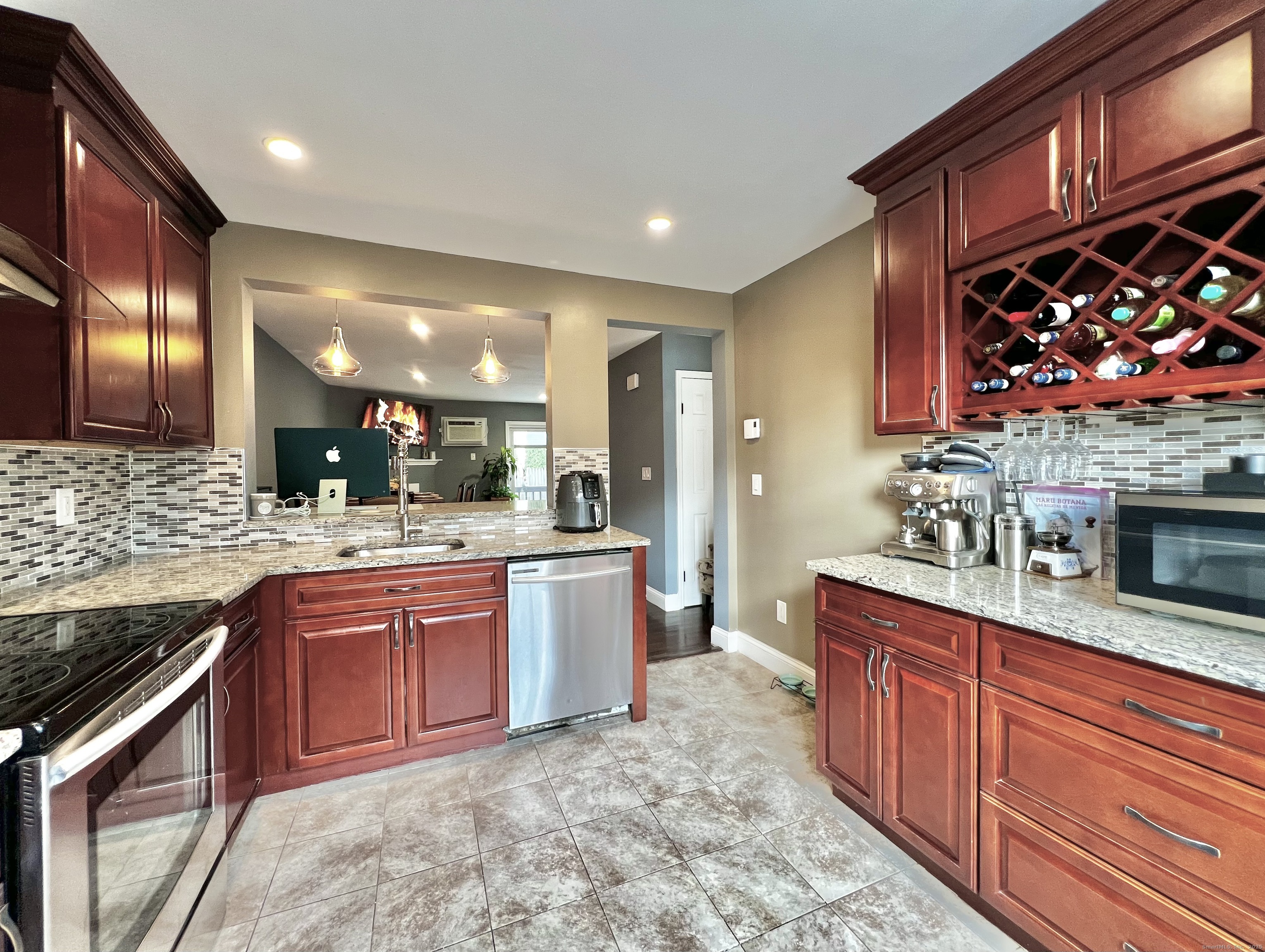 782 Oronoke Road, Unit 27 Waterbury, CT 06708 - Photo 6 of 28 a large kitchen with stainless steel appliances granite countertop a stove a sink and a microwave