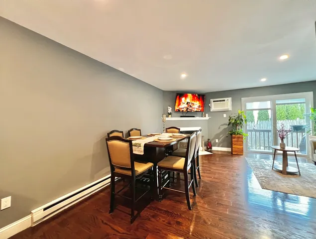 a dining room with furniture and wooden floor