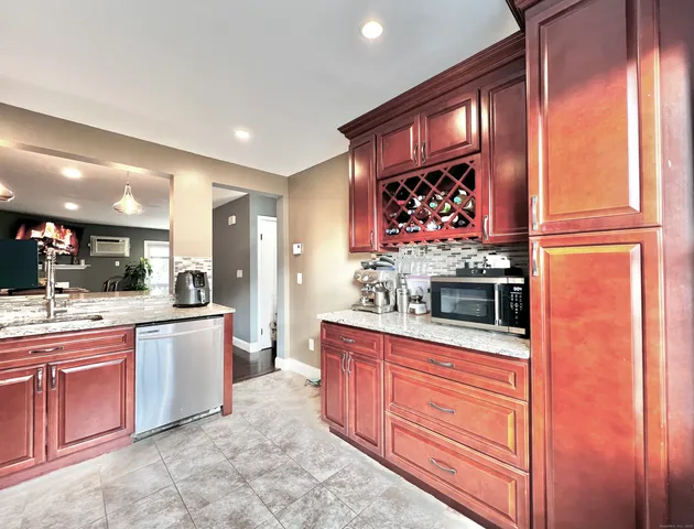 a kitchen with stainless steel appliances granite countertop a stove and a sink