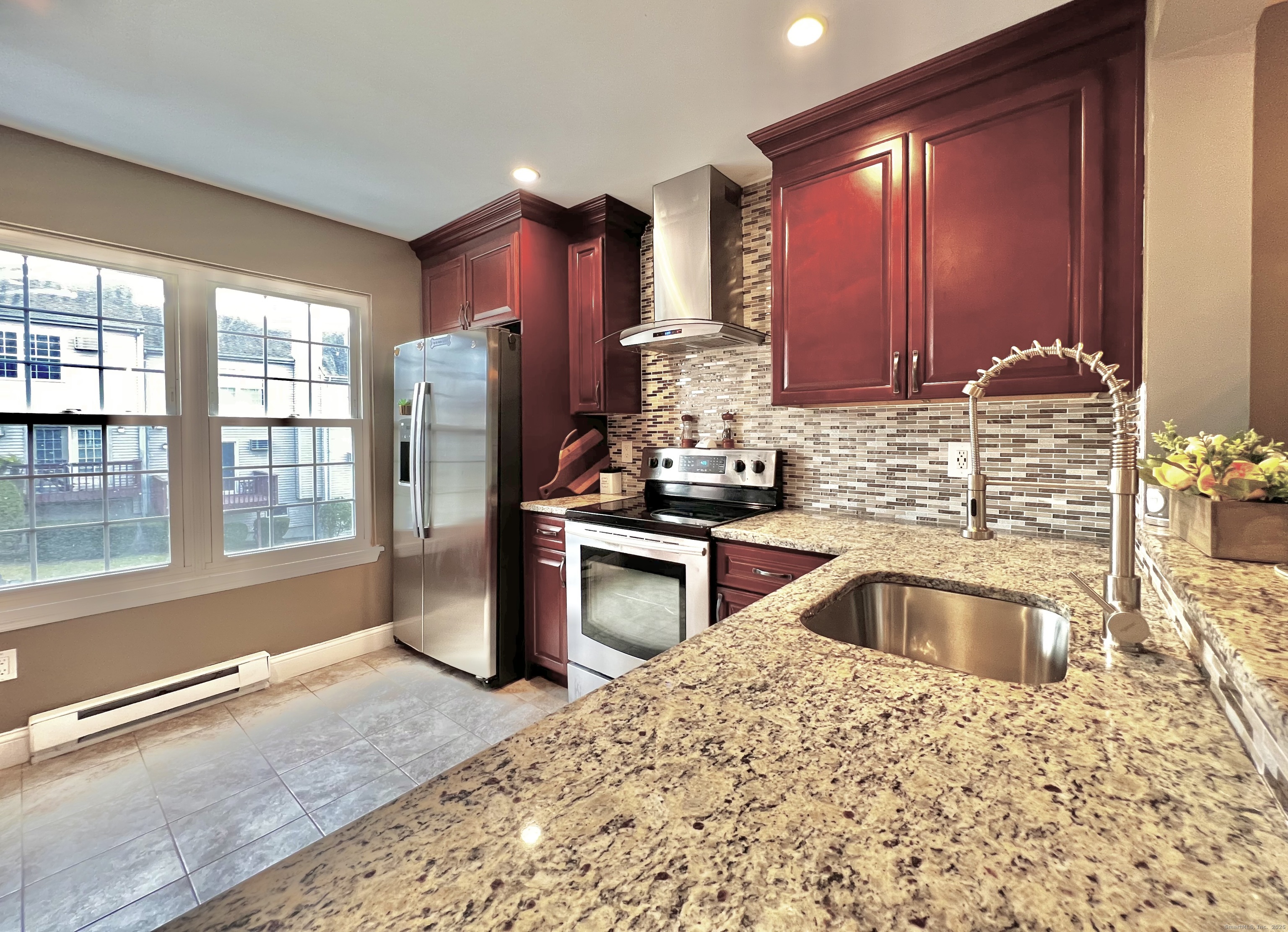 782 Oronoke Road, Unit 27 Waterbury, CT 06708 - Photo 10 of 28 a kitchen with granite countertop a stove and a sink
