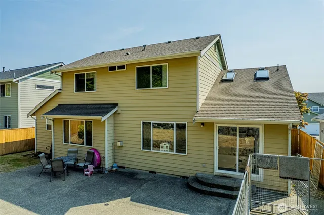 a front view of a house with sitting area