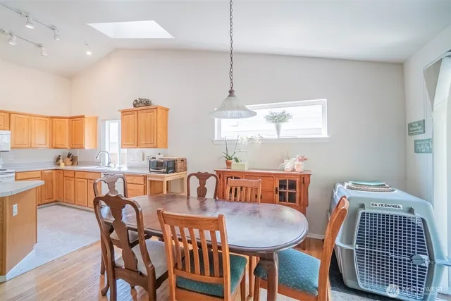 a dining room with furniture a rug and wooden floor