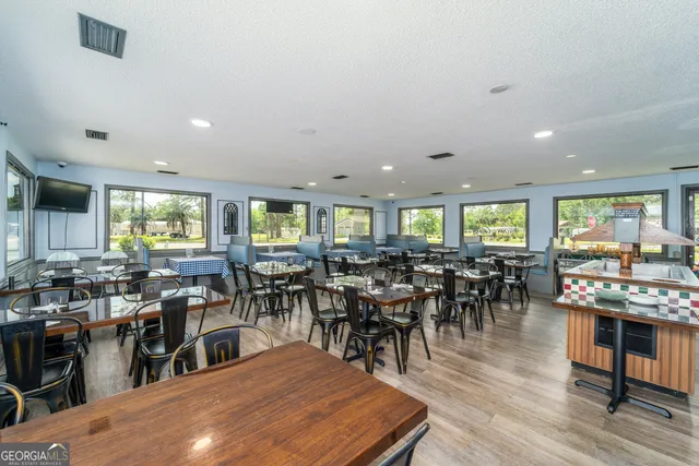 a large dining space with lots of furniture a dining table and chairs