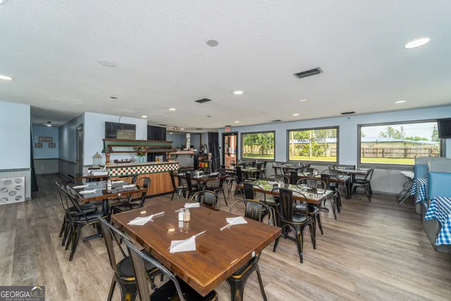 a living room with lots of furniture and kitchen view