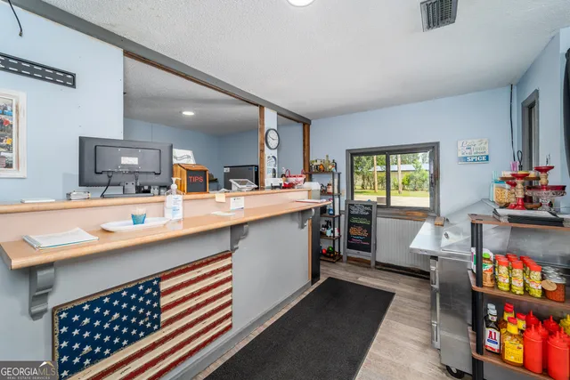 a large white kitchen with a large window