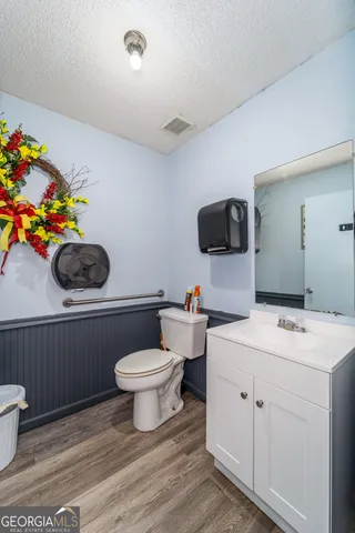 a bathroom with a sink toilet and a mirror