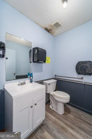 a bathroom with a toilet a sink and mirror