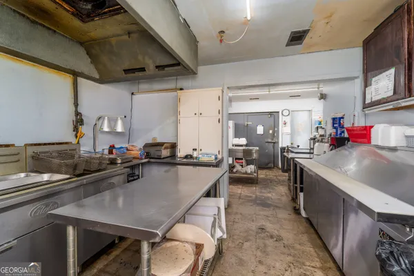 a kitchen with sink a stove and cabinets