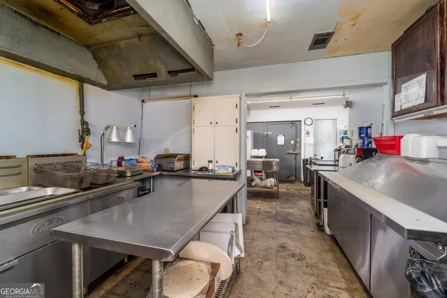 a kitchen with sink a stove and cabinets
