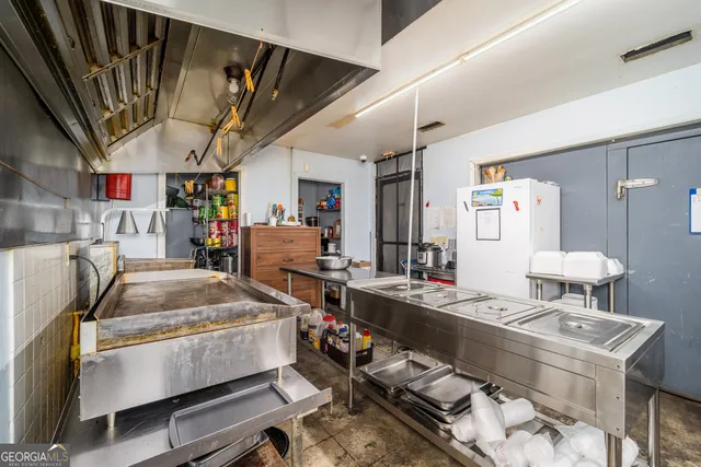 a kitchen with refrigerator and stove