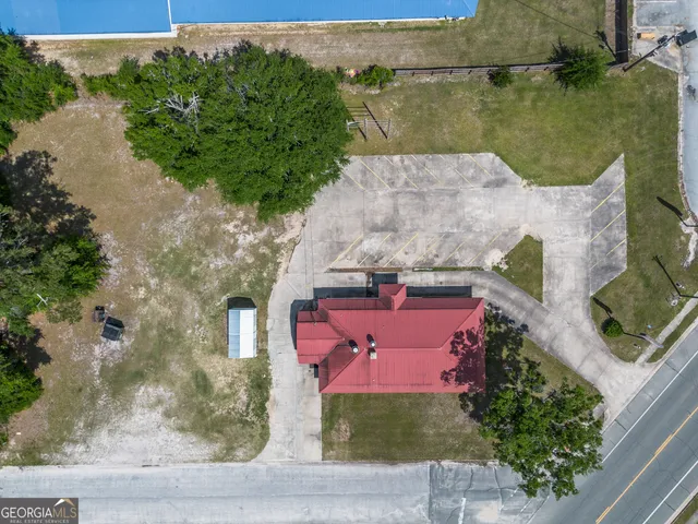 an aerial view of a house with outdoor space and lake view