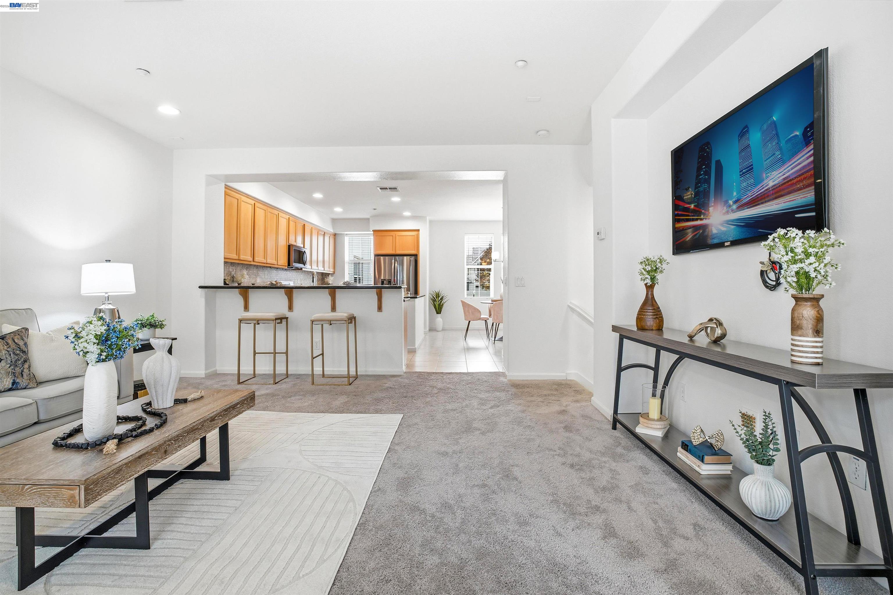 2833 Alnwick Avenue, Unit 7 Livermore, CA 94551 - Photo 14 of 37 a living room with furniture a dining table and paintings on the wall