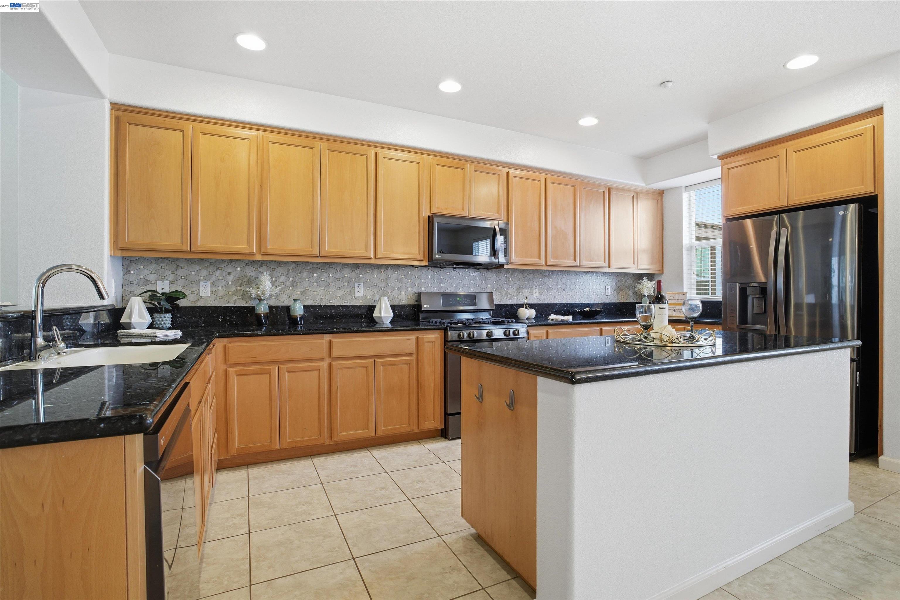 2833 Alnwick Avenue, Unit 7 Livermore, CA 94551 - Photo 18 of 37 a kitchen with granite countertop a sink stove and refrigerator